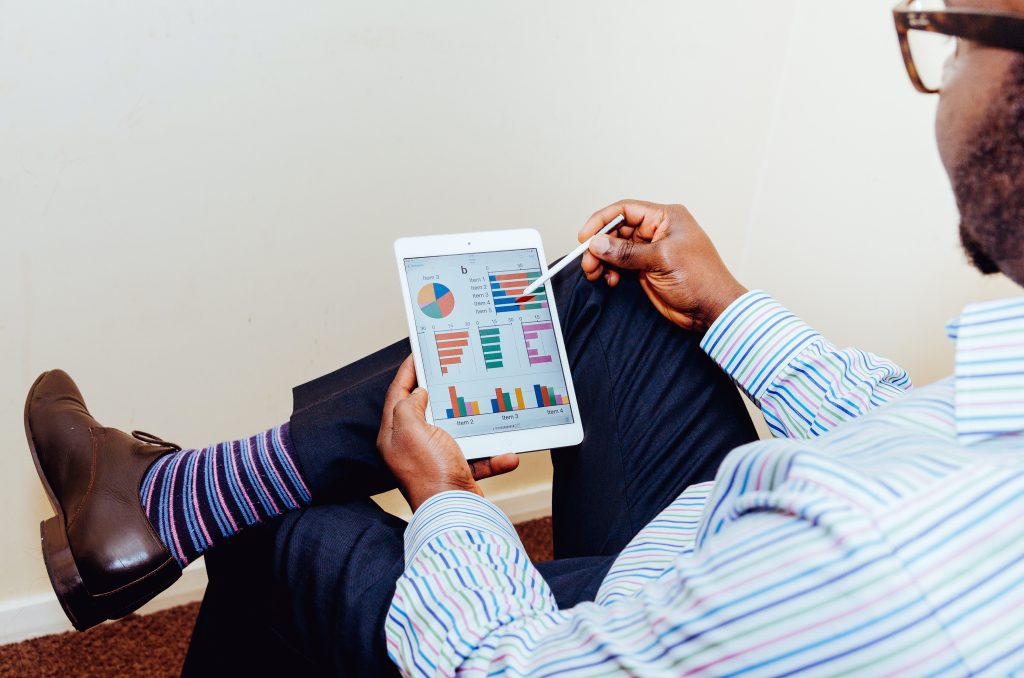 broker viewing a spreadsheet on a tablet screen.